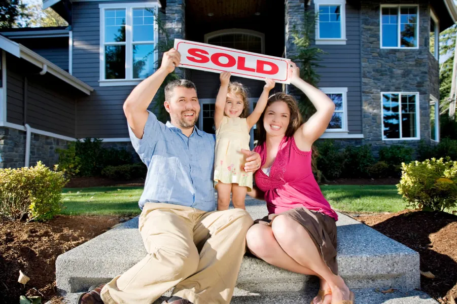 Happy family with recently sold house